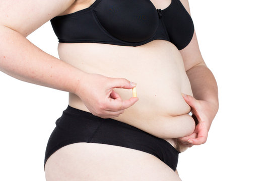 Woman showing her fat body and holding a tablets. Healthy lifestyles concept and diet.
Obese neglected body isolated over white background.