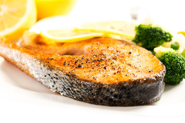 Grilled salmon and vegetables on plate close up