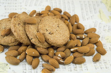 Decoupage table covered with raw almonds and cookies