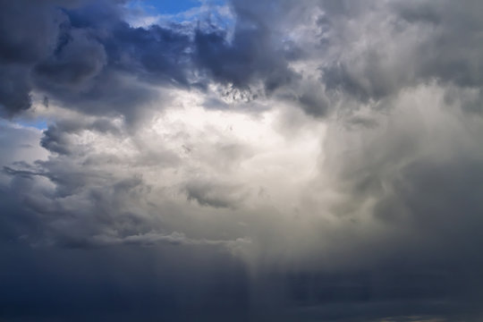 Sunlight is streaming through storm clouds