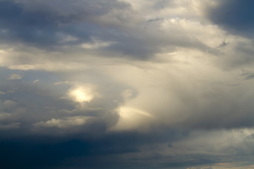 Sunlight is streaming through storm clouds