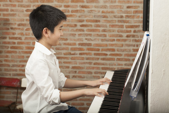 piano lesson, Asian boy kid activity playing piano with notes