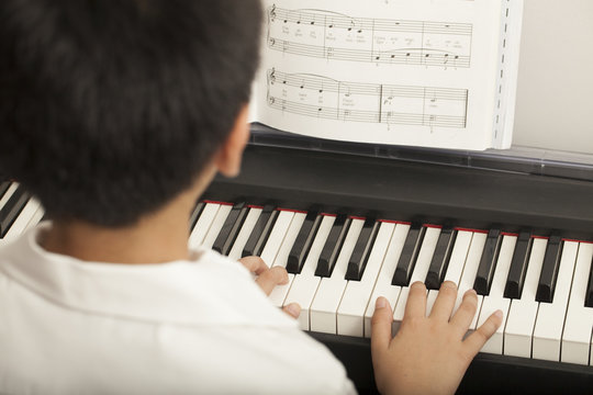 piano lesson, Asian boy kid activity playing piano with notes
