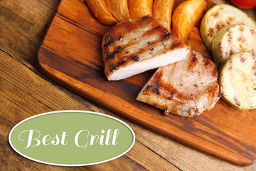 Delicious grilled meat on wooden board 