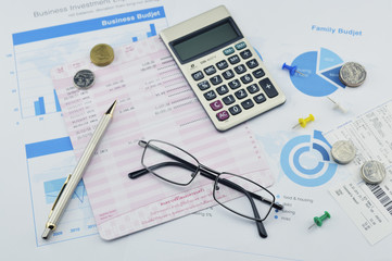 Glasses, pen and coin on graph paper, saving concept