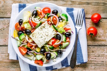 Greek salad of organic vegetables and feta cheese top view