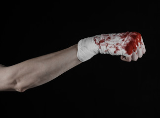 bloody hand in a bandage, bloody bandage, black background