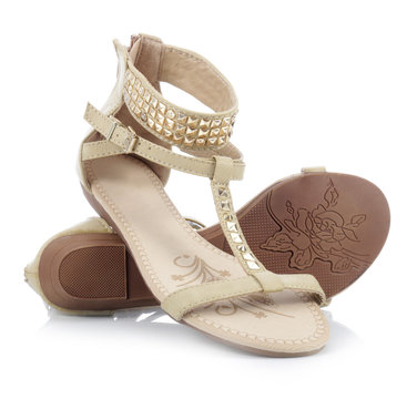 Beige sandals with studs on a white background 