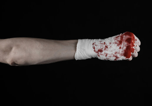 bloody hand in a bandage, bloody bandage, black background