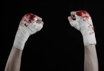 bloody hand in a bandage, bloody bandage, black background
