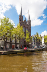 Naklejka premium Krijtberg Kerk church at the Singel canal. Amsterdam.