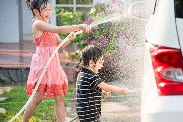 Asian children washing car