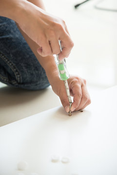 Woman's hand using a screw driver