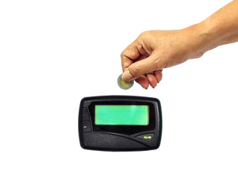 hand putting coin on vintage  pager on white background