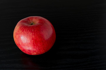 red apple on black background