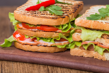 Classic club sandwich with bacon and vegetables