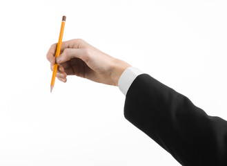 hand of the artist in a black suit holding a pencil isolated