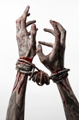Hands bound,bloody hands, mud, rope, on a white background