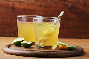 cold gold soft drink from lime and honey with gold straw