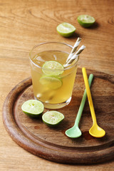 cold gold soft drink from lime and honey with gold straw