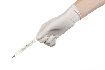 doctor's hand in white gloves holding a thermometer