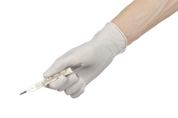 doctor's hand in white gloves holding a thermometer