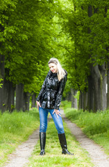 woman wearing rubber boots in spring alley