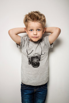 Little pretty boy posing at studio as a fashion model 