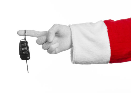 Santa's hand holding the keys to a new car on a white background