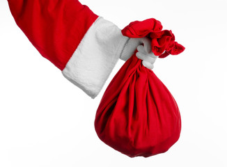 Santa holding a big red sack with gifts on white background