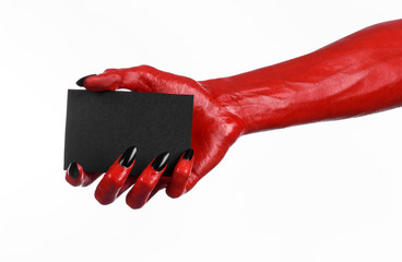 Red devil hand with black nails holding a blank black card