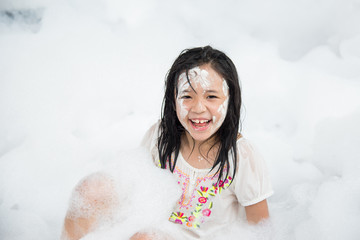 Asian girl smiling in foam party