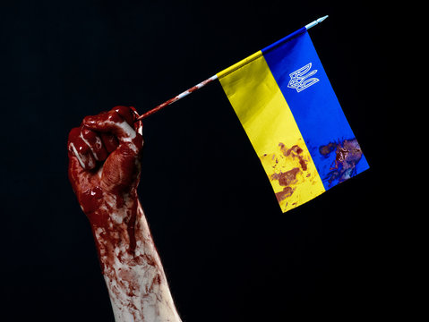 Bloody hands, the flag of Ukraine in the blood, revolution