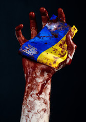 Bloody hands, the flag of Ukraine in the blood, revolution