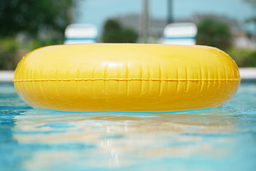 floating ring on blue water swimpool with waves reflecting