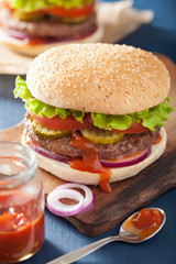 burger with beef patty lettuce onion tomato ketchup