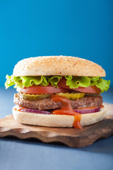 burger with beef patty lettuce onion tomato ketchup