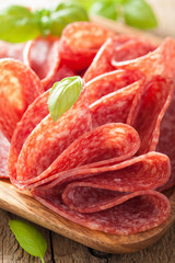 salami slices in wooden plate
