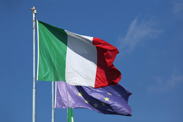 National flags of Italy and a flag of the European Union.