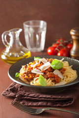 italian pasta spaghetti bolognese with basil on rustic table