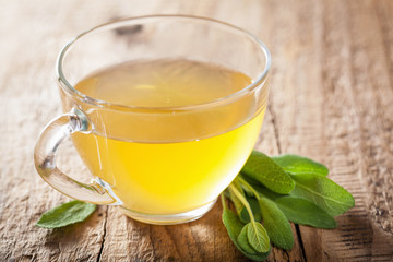 herbal sage tea with green leaf in glass cup