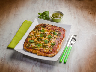 homemade pizza with pesto sauce
