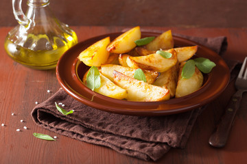 baked potato wedges in plate over brown rustic table