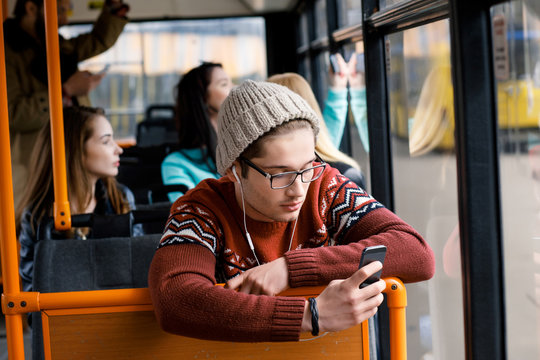 man rides a bus, listening to music