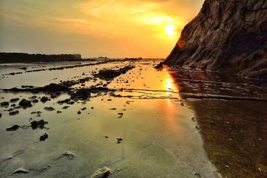Indonesia, Sawarna, Tanjung Layar, Scenic view of landscape at sunset