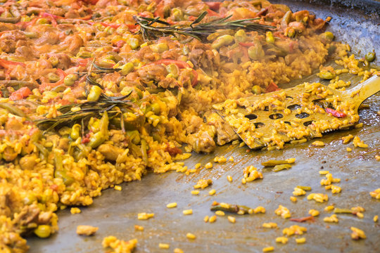 Traditional spanish chicken paella on big pan, food market