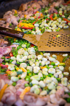 spanish chicken paella preparation, outdoors food market