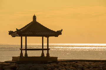 Gazebo on the tropical beach during sunrise. Bali, Indonesia