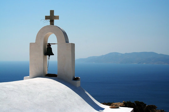 Greece, Ios Island, Bell tower of church, sea and mountain range