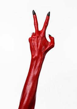 Red Devil's hands, red hands of Satan, white background isolated